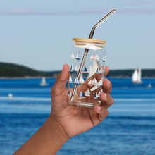 Load image into Gallery viewer, Hand holding an empty glass with a sailboat design in front of an ocean background
