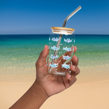 Load image into Gallery viewer, Hand holding glass with shark design in front of ocean background